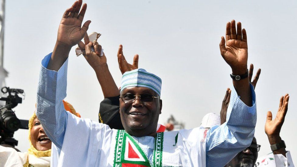 Atiku Abubakar raise hands during a campaign rally in Kano, northwest Nigeria, on 9 February