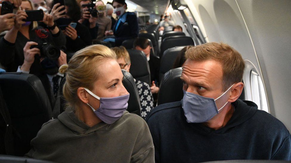 Russian opposition leader Alexei Navalny and his wife Yulia sit in a Pobeda airlines plane heading to Moscow before take-off from Berlin Brandenburg Airport (BER) in Schoenefeld, southeast of Berlin, on January 17, 2021.