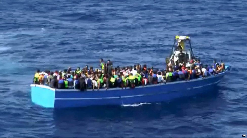 In this photo provided by the Swedish Coast Guard, migrants wait for help from the ship Poseidon after being spotted in a fishing boat off the Libyan coast 26 August 2015.