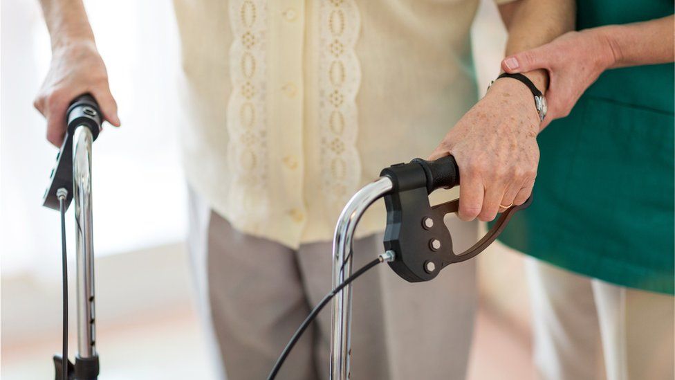 A care worker helping an elderly person