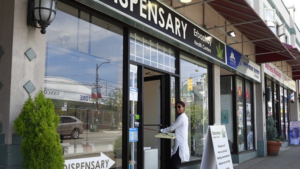 A woman walks into the Erbachay Health Centre Dispensary in Vancouver