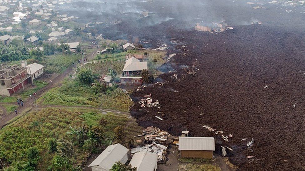 This aerial view shows debris engulfing buildings in Bushara village