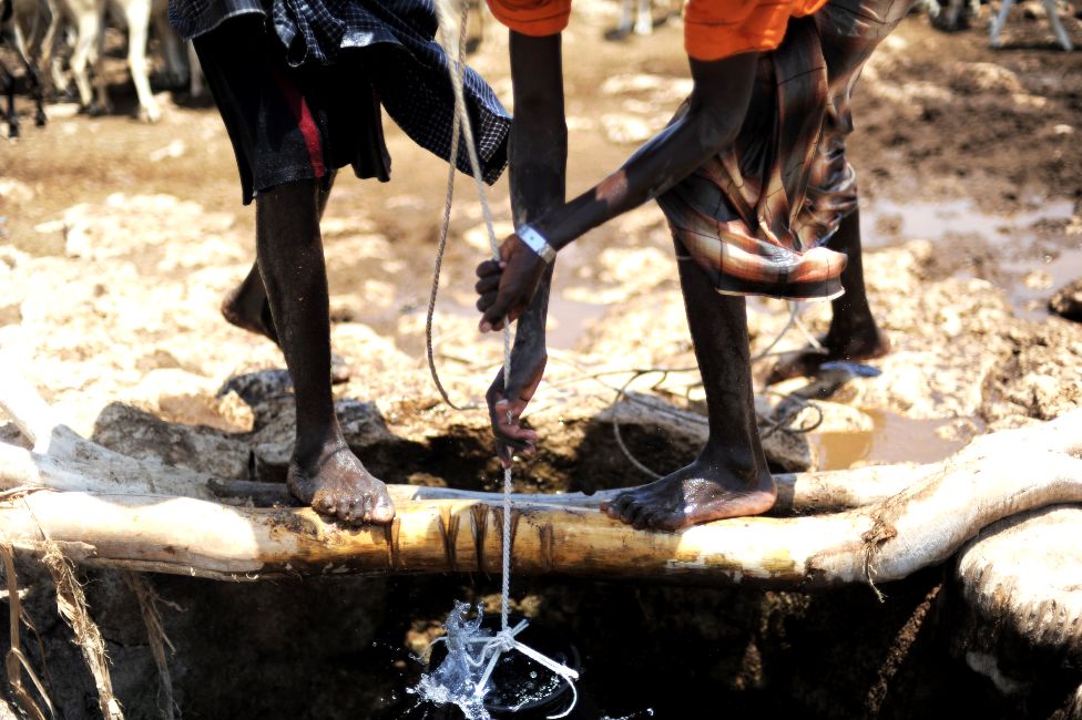 Nomads pulling water from a well for their livestock in Somalia - archive shot
