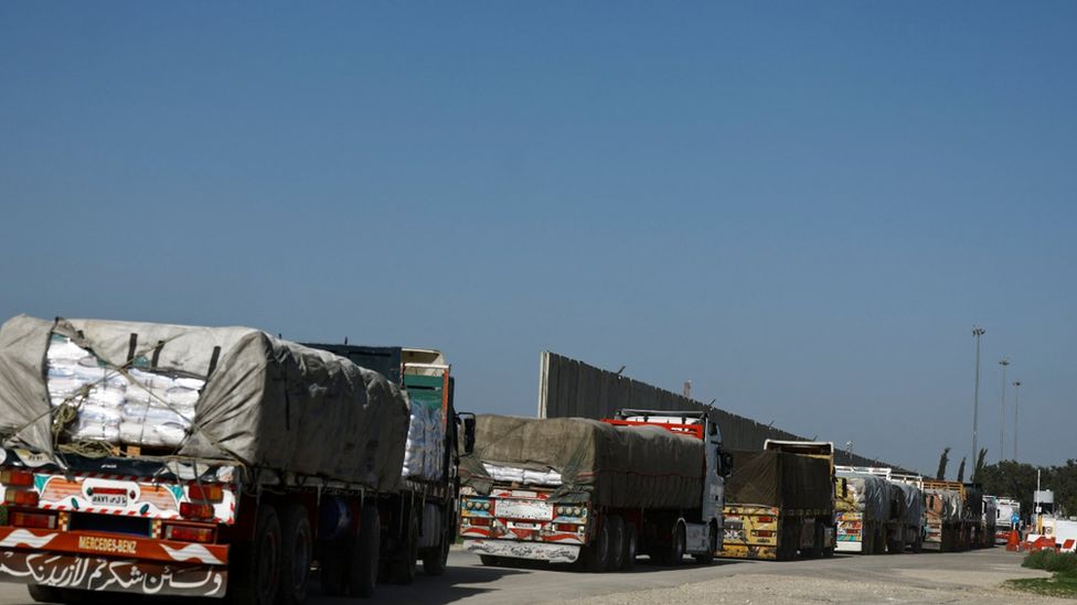 Aid trucks queue to enter Gaza, amid the ongoing conflict between Israel and the Palestinian Islamist group Hamas, at Kerem Shalom crossing, Israel
