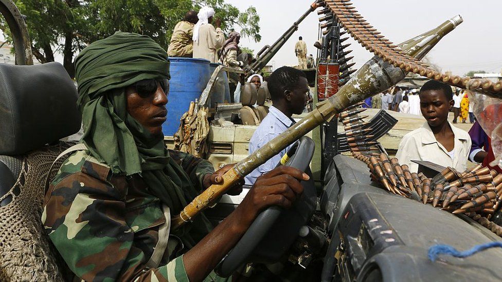 A fighter from the Sudanese Rapid Support Forces sits in an armed vehicle in the city of Nyala, in south Darfur, on May 3, 2015, as they display weapons and vehicles they say they captured from Dafuri rebels and fighters from The Justice and Equality Movement (JEM), lead by opposition leader Jibril Ibrahim, the previous week