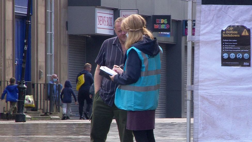 Council worker speaking to man in street