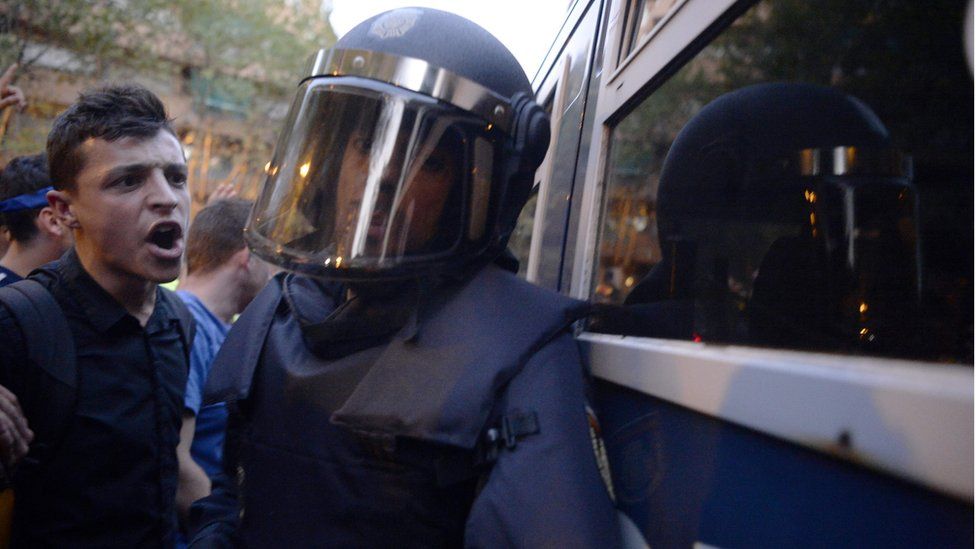 A protester confronts a Spanish policeman in Barcelona, 20 September