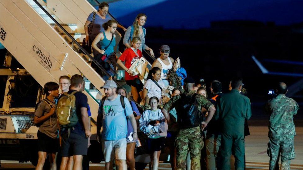Evacuees from Niger seen disembarking an Italian flight in Rome