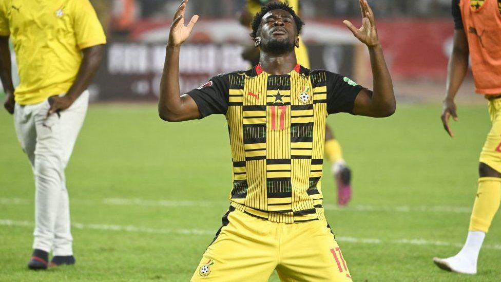 Ghana's Osman Bukari on his knees celebrating on the pitch after Ghana qualified for the World Cup