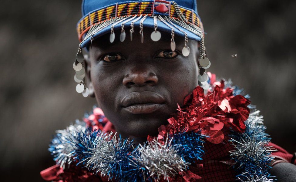 A young man from Kenya's Maasai ethnic group poses after coming out of the bush on Wednesday after a month-long circumcision ceremony, which serves as a rite of passage to adulthood.