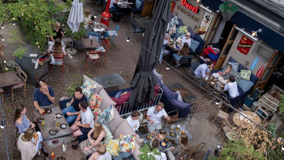 An aerial view of customers enjoying al fresco dining and drinking at a bar