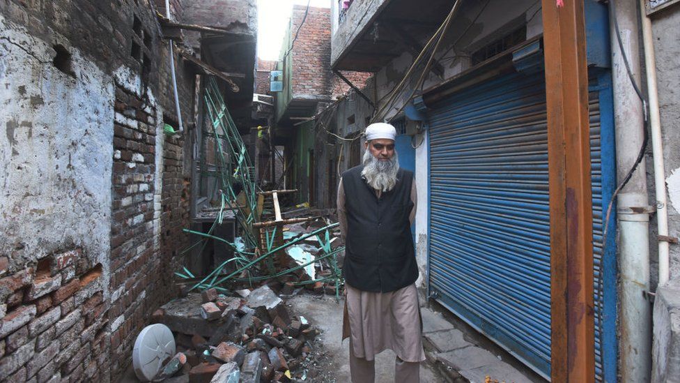 A resident passes by a burnt house after communal violence in northeast Delhi last week over the Citizenship Amendment Act (CAA), at Shiv Viihar, on March 5, 2020