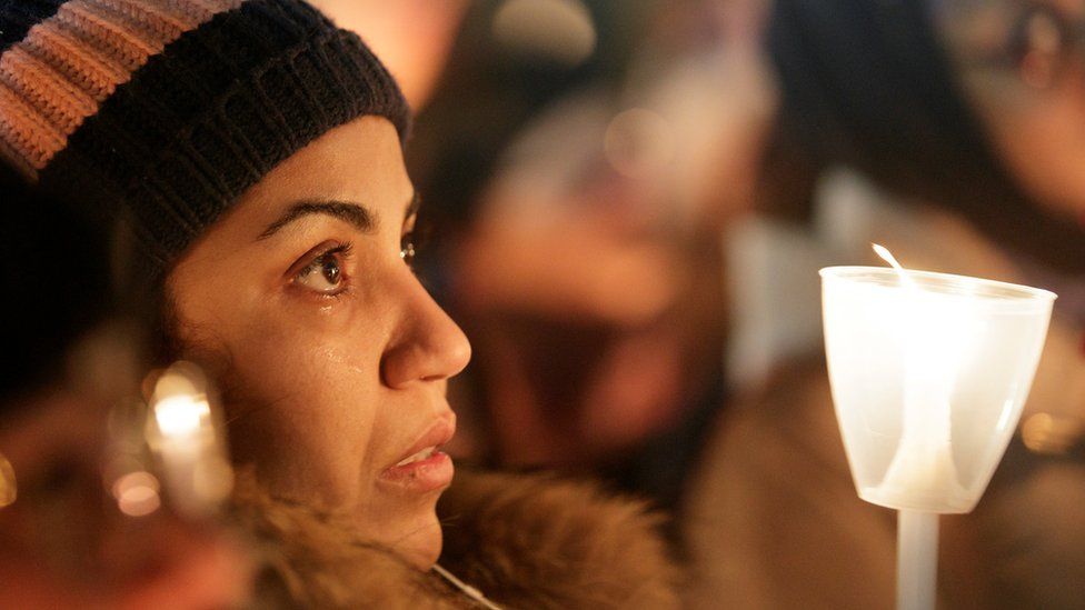 A woman becomes emotional during a vigil in support of the Muslim community in Montreal, Quebec, January 30, 2017.