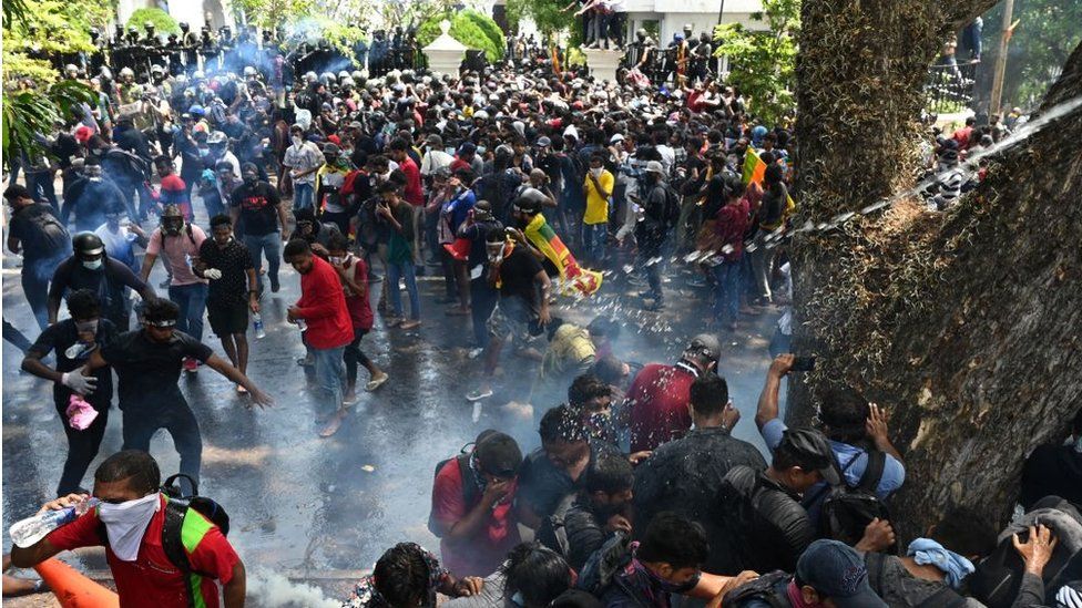 Unseen army personnel use tear gas to disperse demonstrators during an anti-government protest outside the office of Sri Lanka's prime minister in Colombo