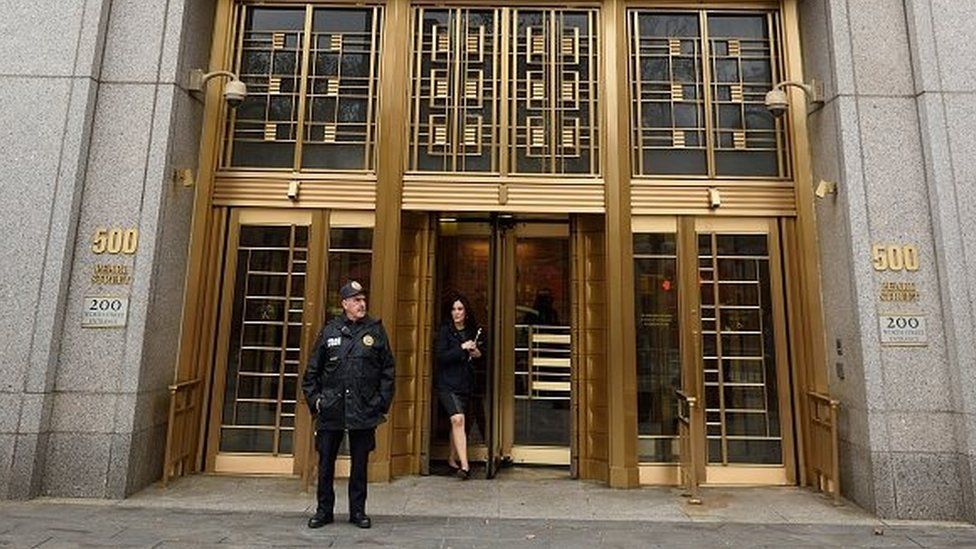 An officer stands guard at the entrance to the US Federal Courthouse on 12 November, 2015