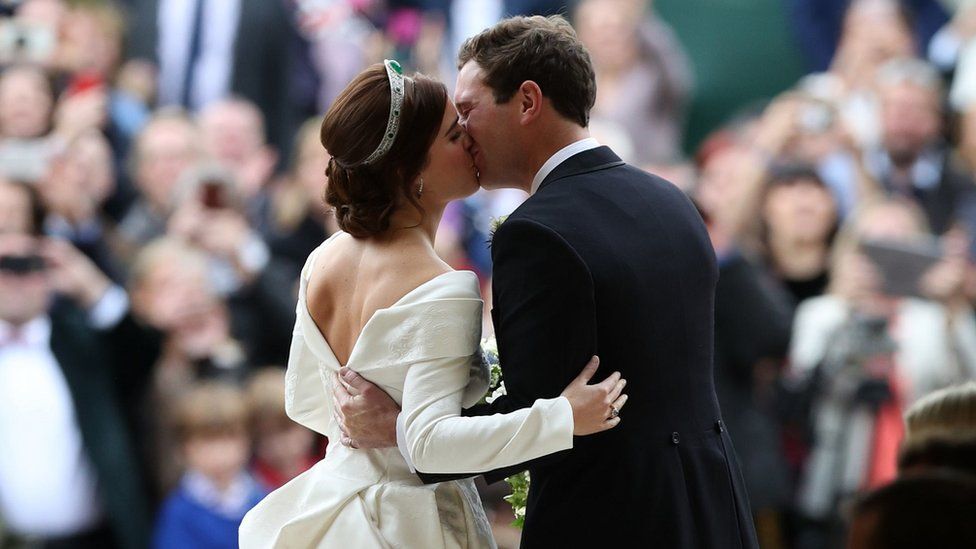 Princess Eugenie and her new husband Jack Brooksbank kiss as they leave St George"s Chapel in Windsor Castle following tehir wedding