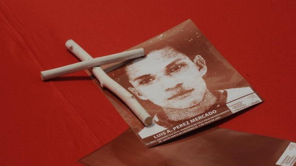 The picture of a murdered young man is seen during a march against the false positives on 6 March, 2009, in Bogota.