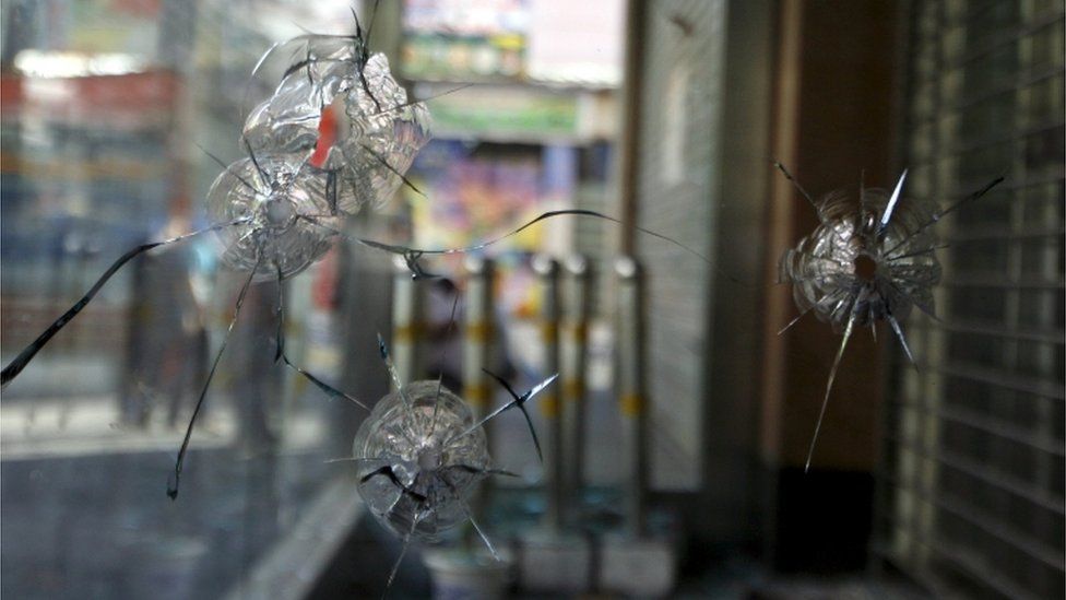 Bullet holes are pictured in the glass window of a Bank of China office located near the Dong Kuruk Bridge mosque in the city of Urumqi in China"s Xinjiang Autonomous Region in this July 11, 2009 file photo.