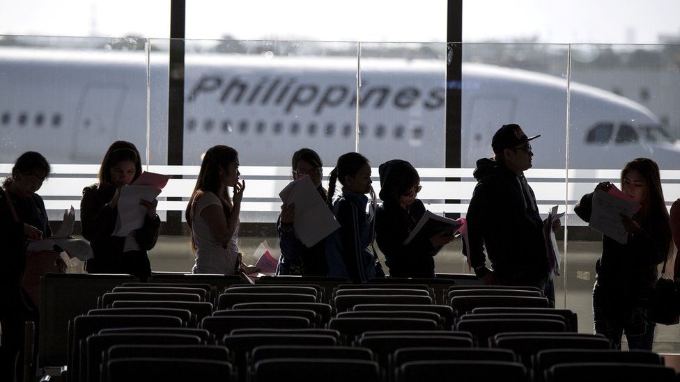 In this file photo taken on February 18, 2018 Filipina workers returning home from Kuwait arrive at Manila International Airport.