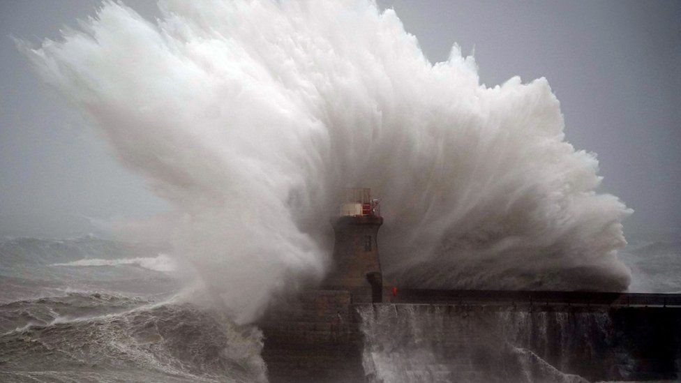 A wave hits South Shields Lighthouse after its dome was removed