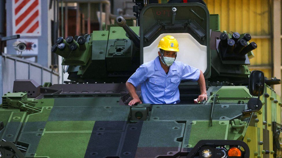 A staff member works on the production line of an armoured vehicle built Taiwan's military