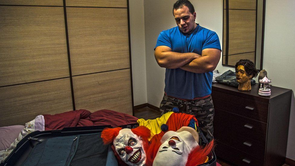Matteo Moroni with killer clown costumes in a suitcase