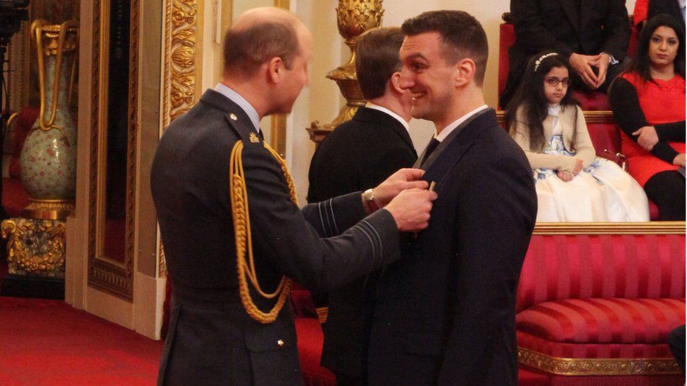 Prince William presenting Sam Warburton with his OBE at Buckingham Palace