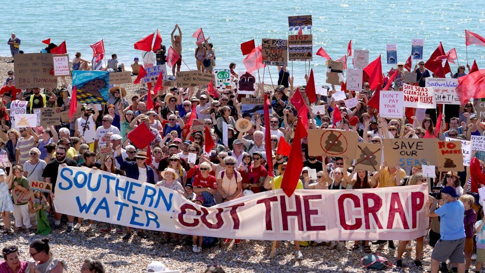 Protesters on a beach in St Leonards, Sussex, demonstrate against the release of raw sewage into the sea