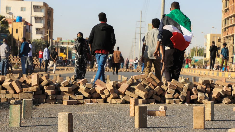 Protesters by bricks at a barricade in Khartoum, Sudan - January 2022