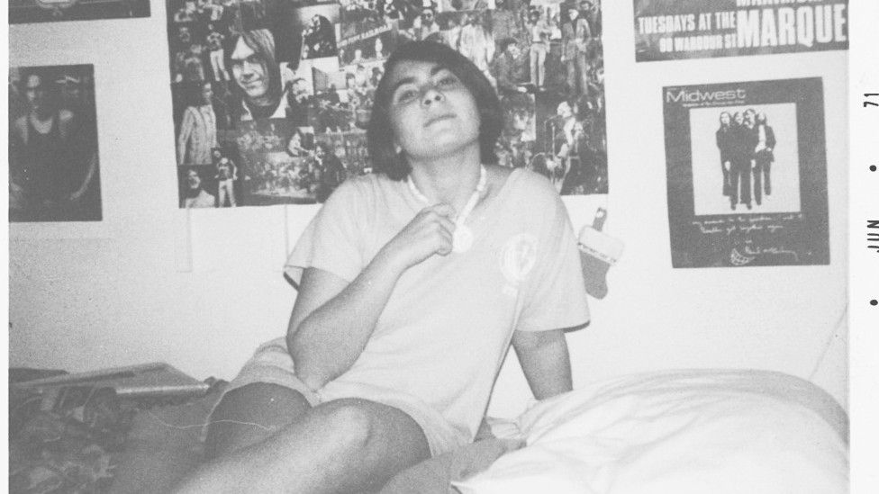 Barbara Charone pictured on her bed as a teenager surrounded by posters of British bands