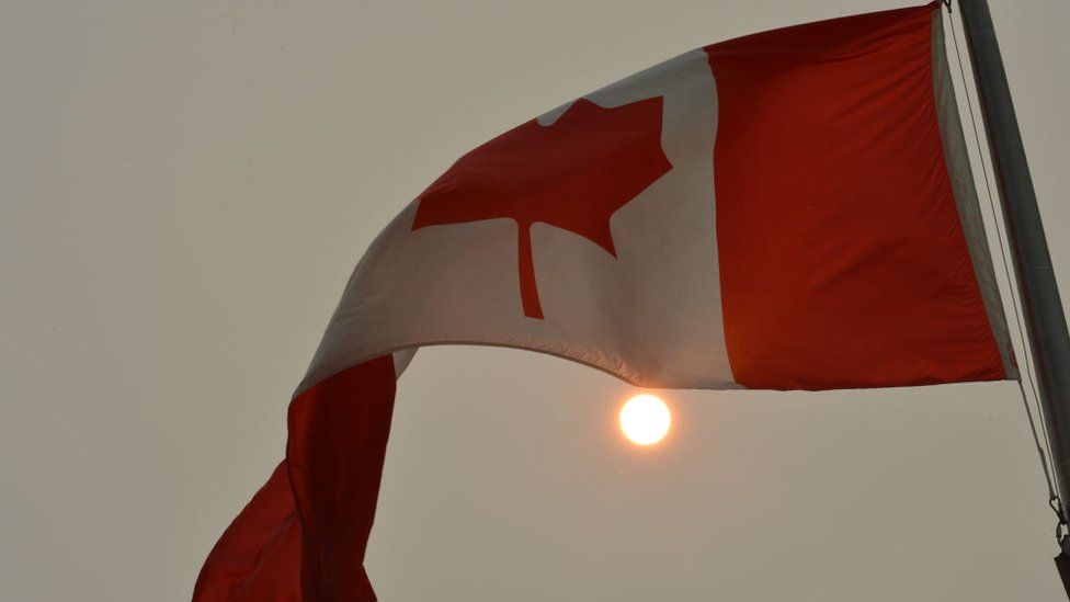 Canadian flag and hazy sun