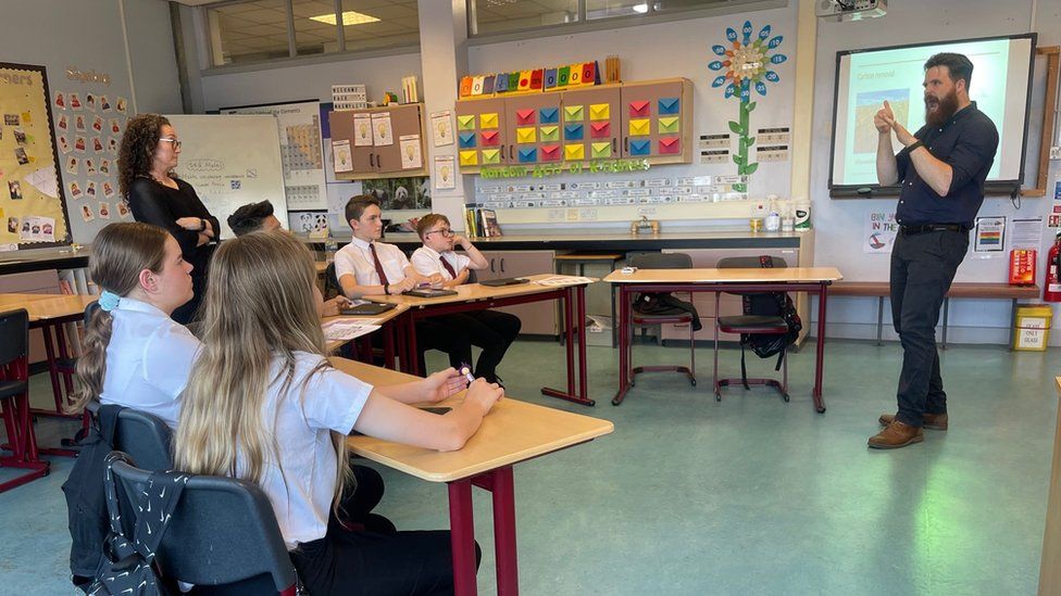 A science class led by a teacher using British Sign Language