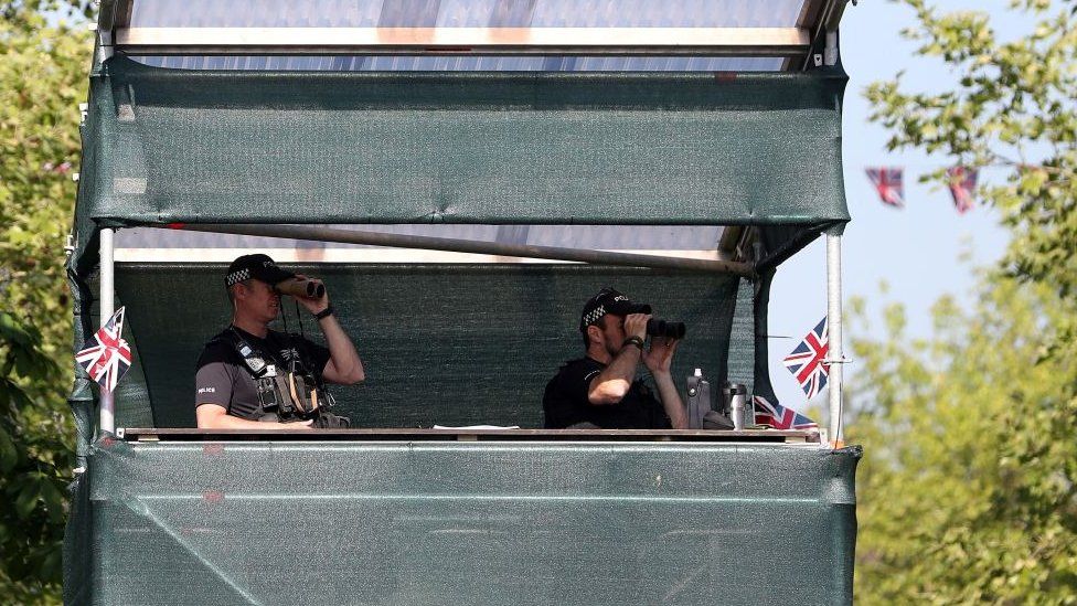 Police officers standing in a make-shift tower
