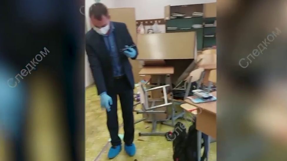 Man wearing gloves and mask in school building