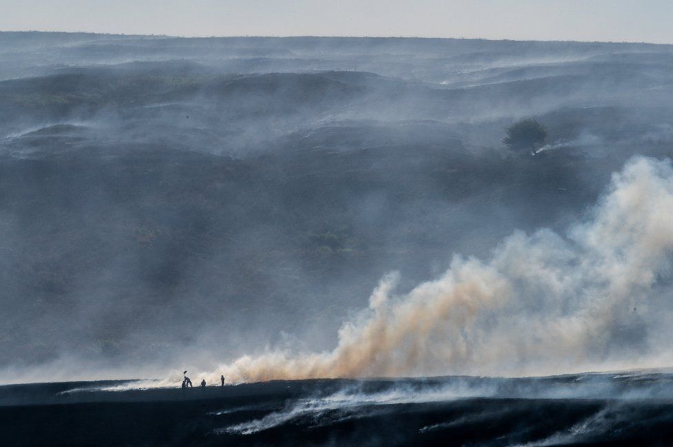A distant view of Winter Hill near Bolton, shows the massive task firefighters are facing to control hundreds of smouldering embers on 2 July 2018.