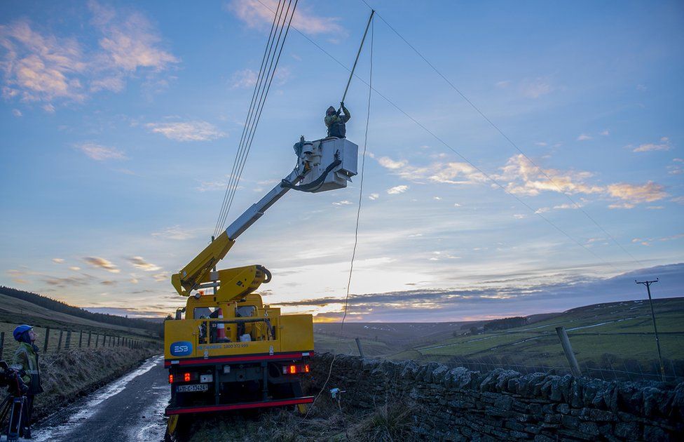Northern Powergrid truck and cherry picker with engineer repairing overhead power line