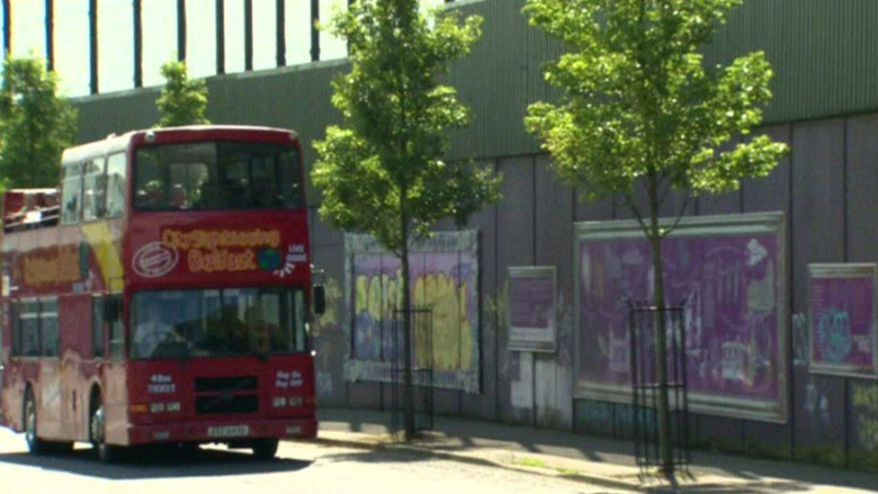 Tourist bus at peace wall