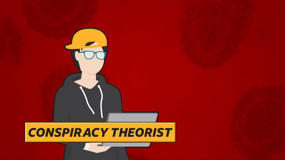 "Conspiracy theorist": Man in glasses and hoodie sitting at laptop