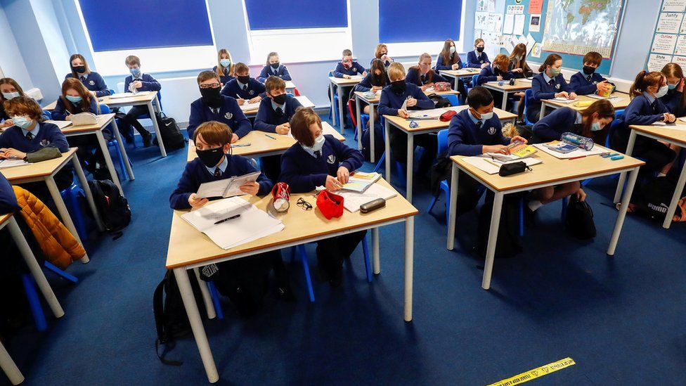 Children in masks in a classroom