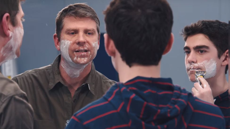 A father and son shaving in a Gillette video