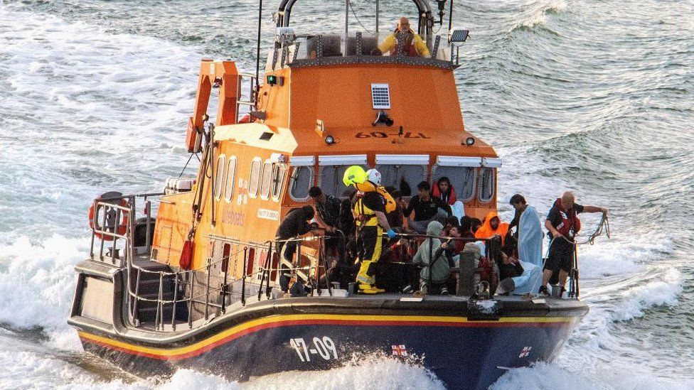 People being brought ashore in a RNLI boat