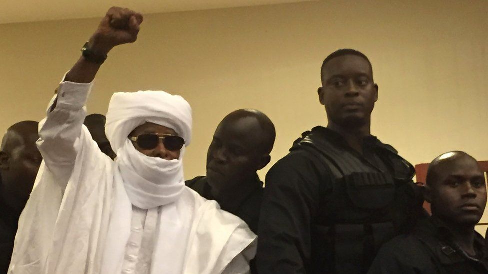 Hissene Habre raises his fist in the air during Monday's hearing