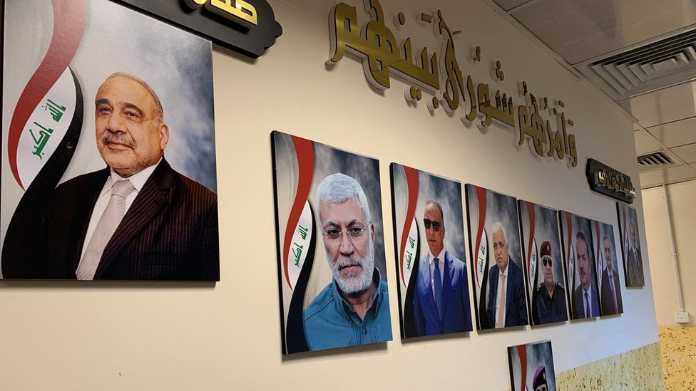 A picture of Iraqi militia leader al-Muhandis (second from left) on the wall at the Union III base