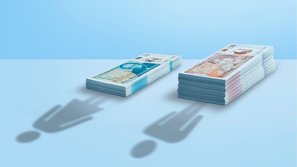 Cash piles with shadow of woman and man - gender pay gap