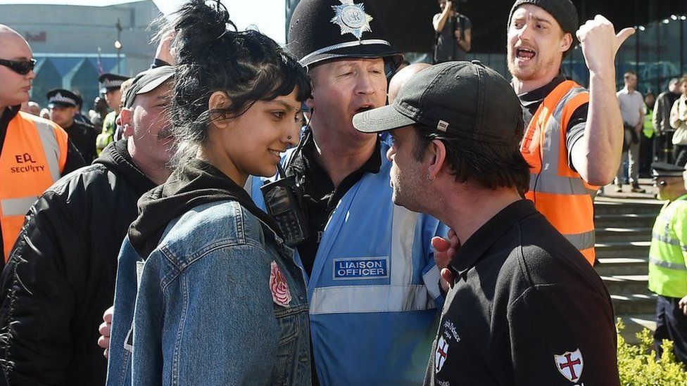 Saffiyah Khan (left) faces down English Defence League (EDL) protester Ian Crossland during a demonstration in the city of Birmingham, in the wake of the Westminster terror attack.