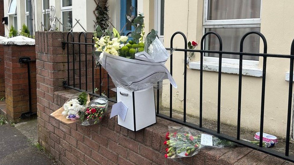 Flowers left at the house where Kathryn Parton was found dead