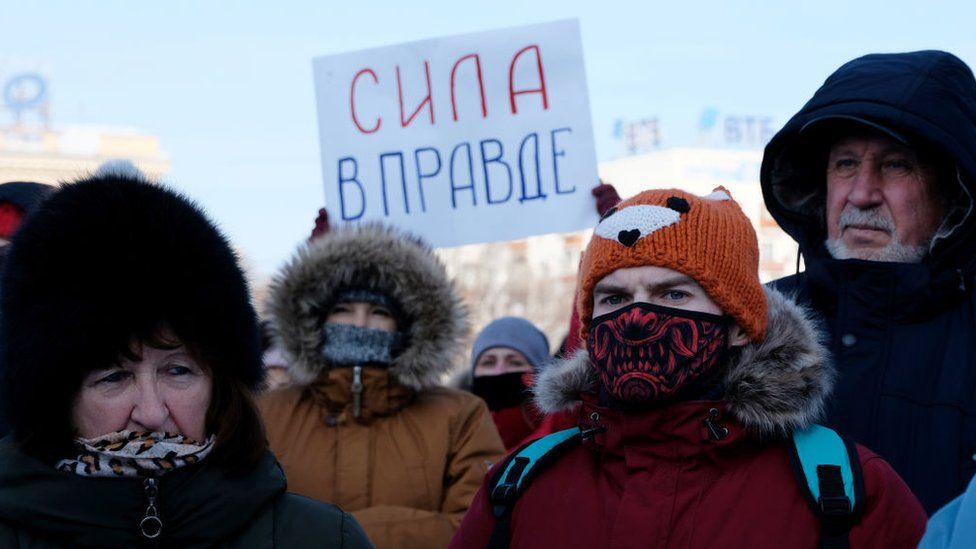 A participant holds a poster reading "Strength is in the Truth" during an unauthorized rally Khabarovsk