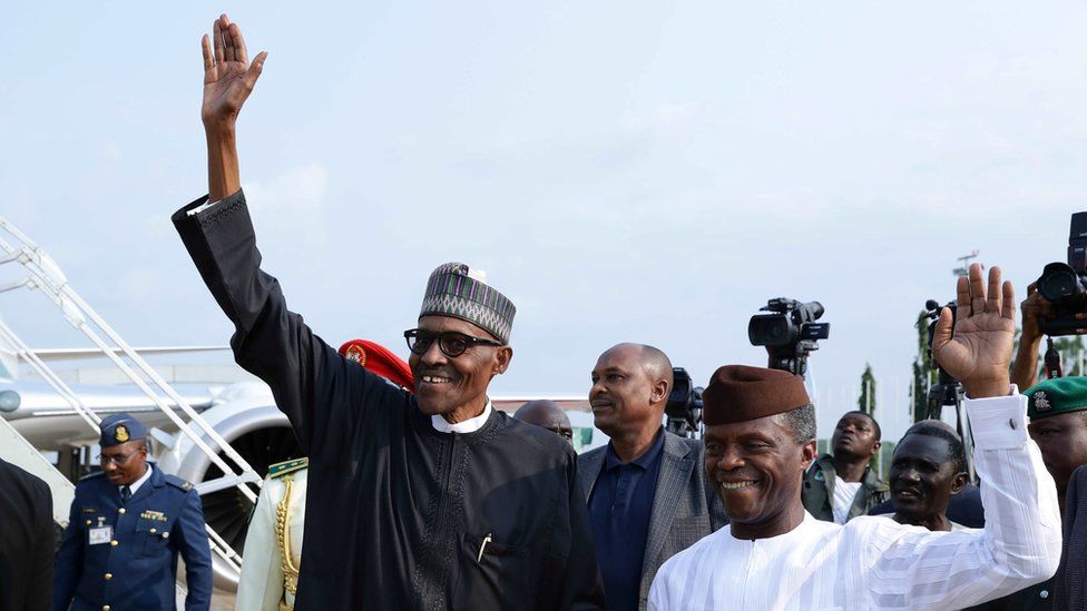 President Buhari and his deputy, Yemi Osinbajo, wave as they arrive in Abuja