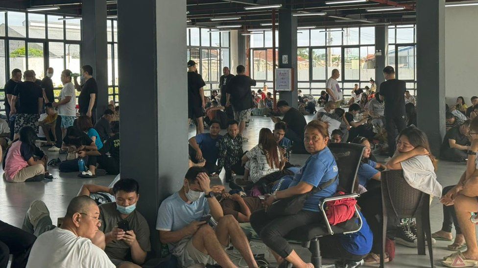 People at the scam centre in Bamban, the Philippines, after a raid