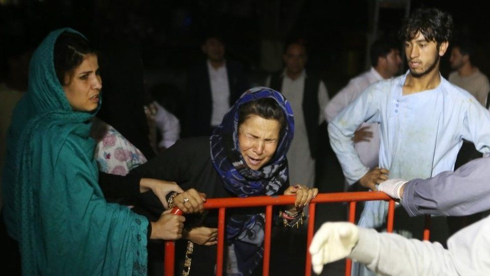 A woman cries outside a hospital after the blast
